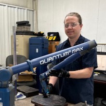 Photo of Nathan Jones standing behind a Quantum Max arm.